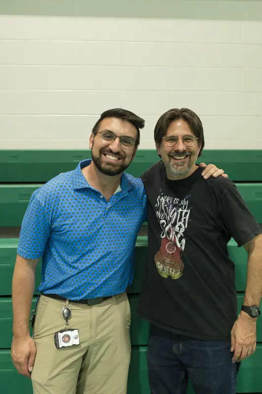 Two fathers of the parish side by side, smiling