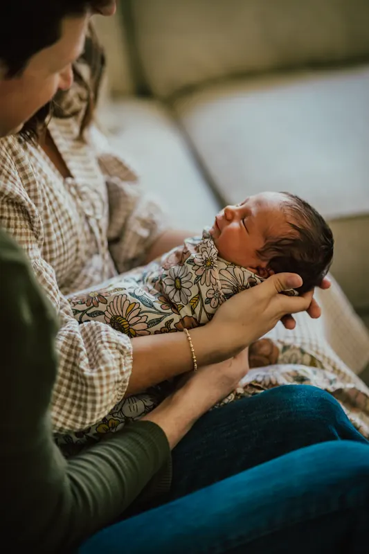 A mother cradling her newborn